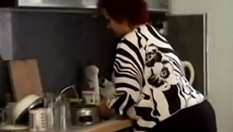 A Voluptuous Mature Woman Receives Sexual Pleasure In The Kitchen